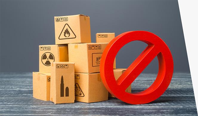 Brown boxes marked with symbols for ammunition, mercury, and radioactive and flammable items, next to a red circle with a slash through it.